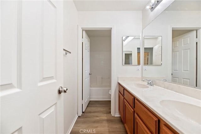 1984 Bronte Rd, San Jacinto, CA 92583 - full bath with double vanity, wood finished floors, a sink, and a bathtub