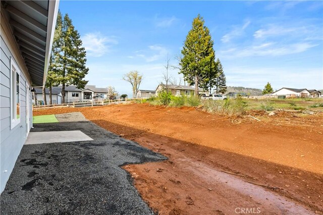 view of yard featuring a residential view and a patio