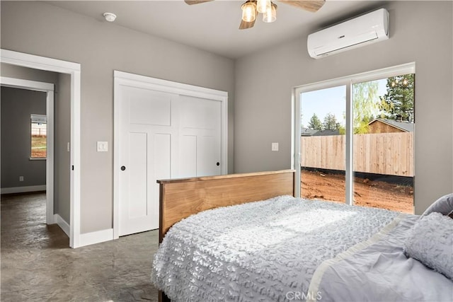 bedroom featuring an AC wall unit, baseboards, access to outside, and multiple windows