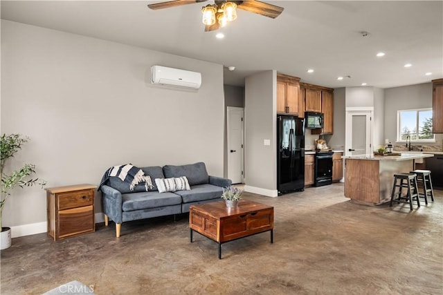 living area with a ceiling fan, concrete flooring, recessed lighting, and a wall mounted air conditioner