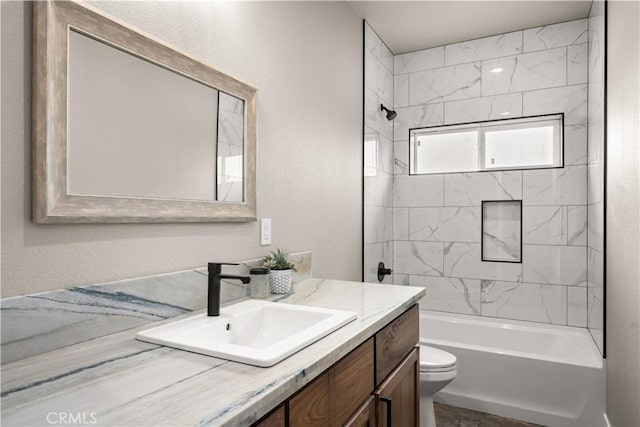 bathroom with toilet, vanity, and shower / tub combination