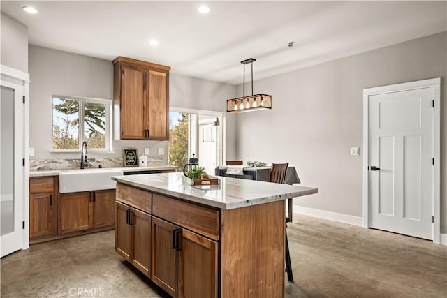 kitchen with brown cabinets, a center island, a sink, and a breakfast bar area
