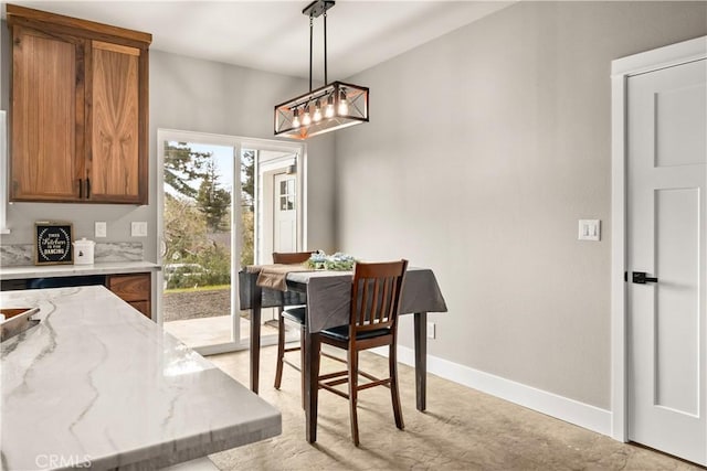 dining space featuring baseboards