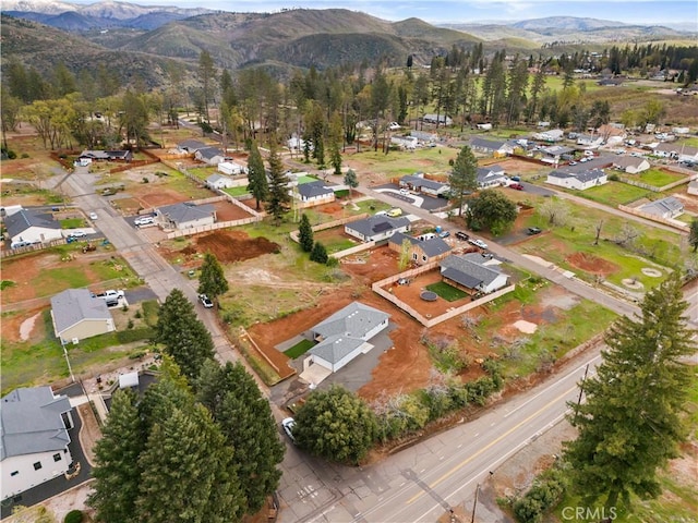 drone / aerial view featuring a residential view and a mountain view