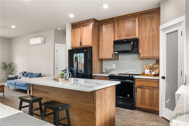 kitchen featuring recessed lighting, a wall mounted air conditioner, a kitchen breakfast bar, a kitchen island, and black appliances