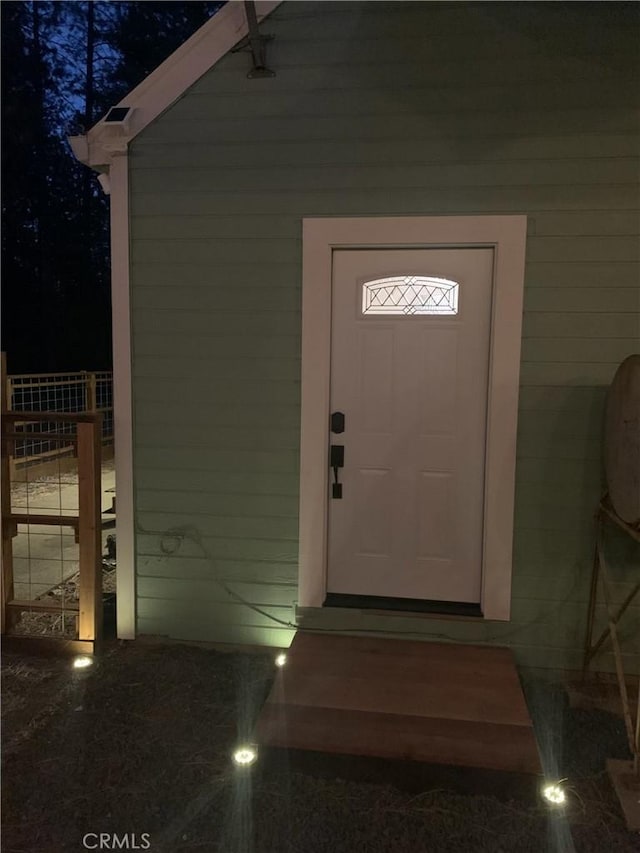 view of exterior entry at night