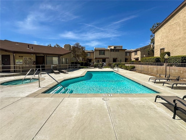 pool featuring a patio, a residential view, and fence