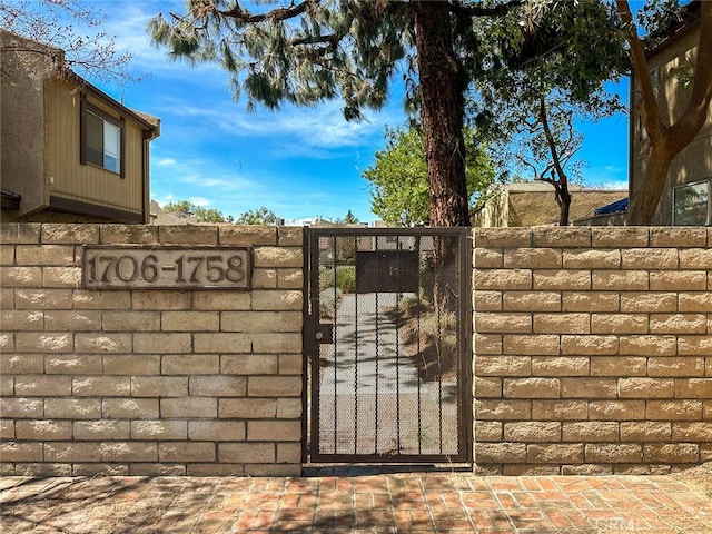 view of gate with fence