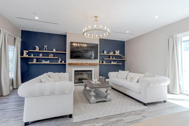 living room with recessed lighting, wood finished floors, and a chandelier