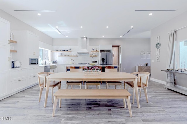 dining area with a toaster, baseboards, recessed lighting, and light wood-style flooring