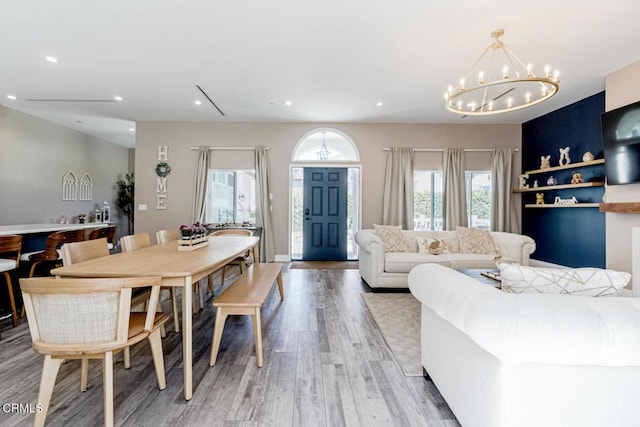 dining area with recessed lighting, an inviting chandelier, and light wood finished floors
