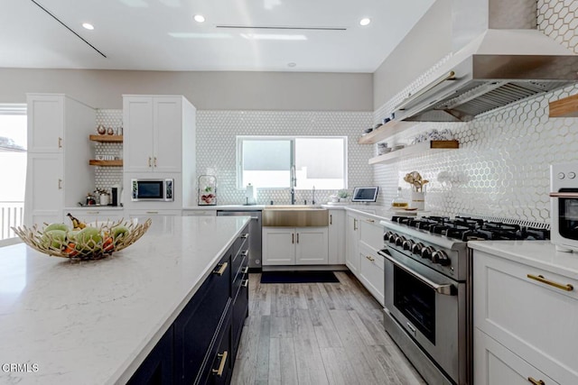 kitchen with white cabinets, open shelves, appliances with stainless steel finishes, and a sink