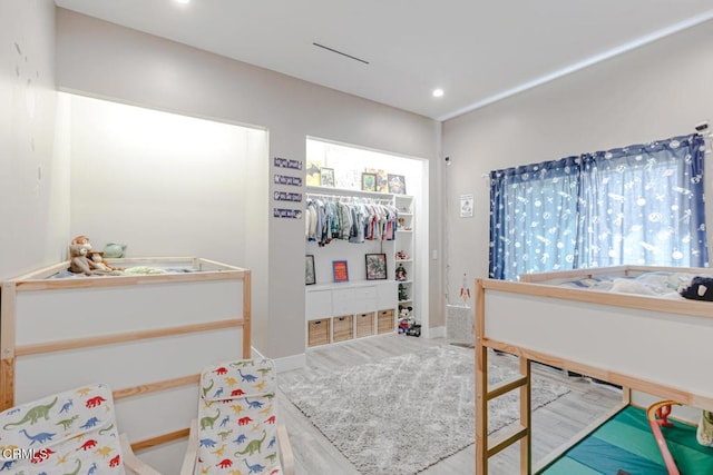 bedroom featuring baseboards, multiple windows, and recessed lighting
