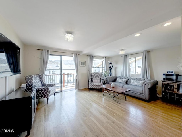 living area with recessed lighting and light wood finished floors