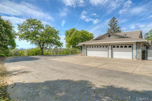exterior space featuring driveway and fence