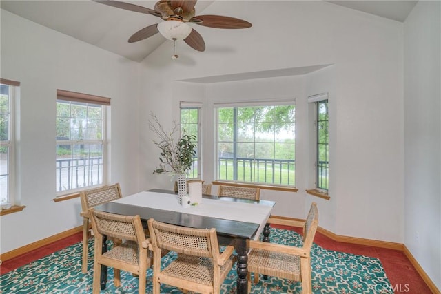 dining space with lofted ceiling, baseboards, and a ceiling fan