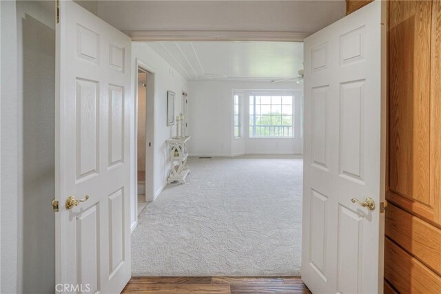 hall with carpet and baseboards