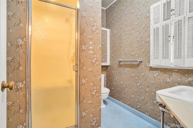 bathroom with toilet, tile patterned floors, and wallpapered walls