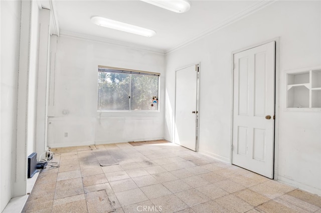 unfurnished room with tile patterned floors, baseboards, and ornamental molding
