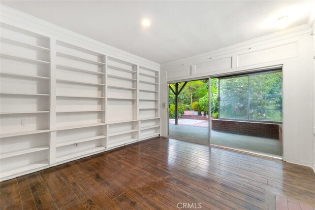 unfurnished room with built in features and dark wood-style floors