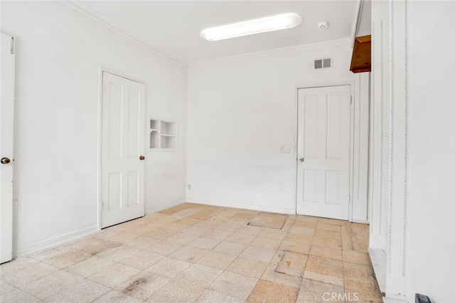 unfurnished room featuring visible vents, baseboards, and ornamental molding