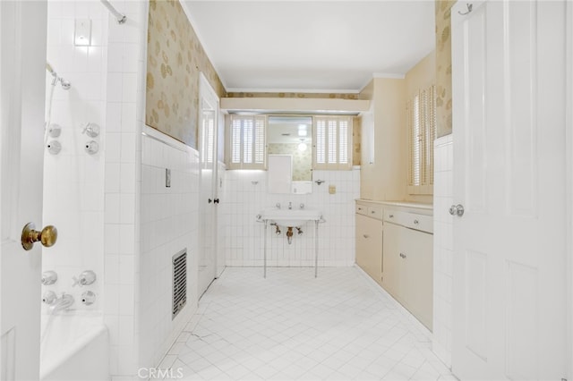 full bath with wallpapered walls, visible vents, shower / bathtub combination, and tile walls
