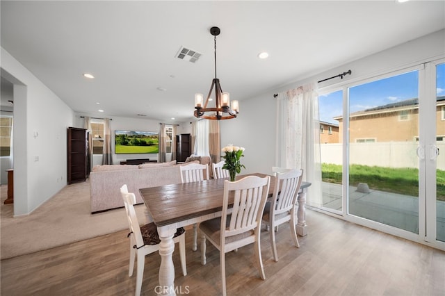dining room featuring light wood-type flooring, visible vents, recessed lighting, and a notable chandelier