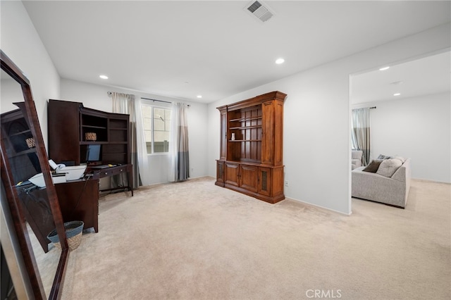 interior space featuring light colored carpet, visible vents, and recessed lighting