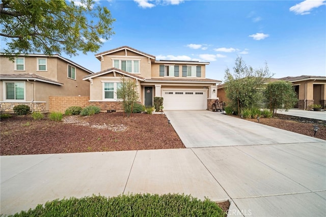 craftsman-style home featuring stucco siding, fence, stone siding, driveway, and a garage
