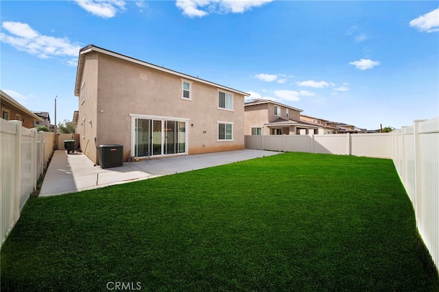 back of property featuring stucco siding, a patio, a fenced backyard, central AC, and a yard