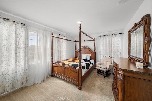 bedroom featuring light carpet