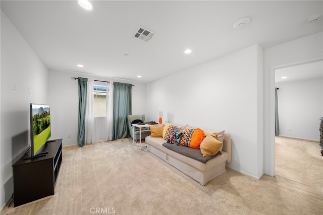 carpeted living room with visible vents and recessed lighting