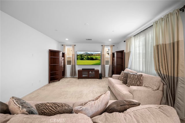 living room with recessed lighting, light carpet, and visible vents