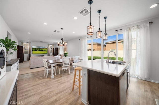 kitchen featuring visible vents, recessed lighting, light wood-type flooring, and a sink