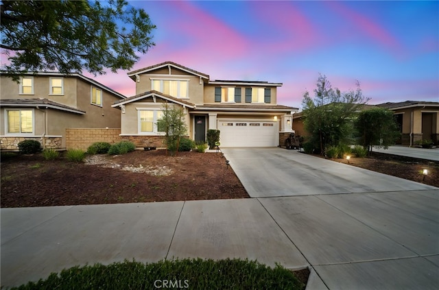 craftsman inspired home with concrete driveway, stucco siding, fence, an attached garage, and roof mounted solar panels