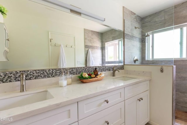 bathroom with plenty of natural light, a sink, and a walk in shower