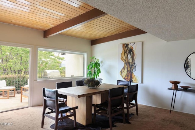 dining room with wooden ceiling, carpet, and beam ceiling