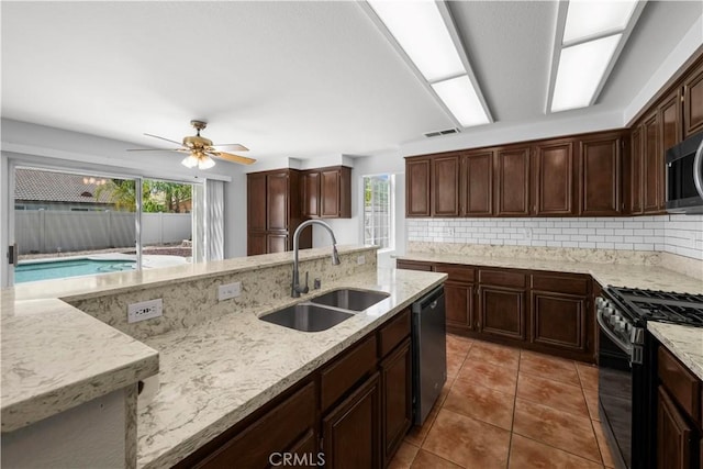 29841 Hazel Glen Rd, Murrieta, CA 92563 - kitchen featuring range with gas cooktop, a sink, dishwashing machine, backsplash, and visible vents