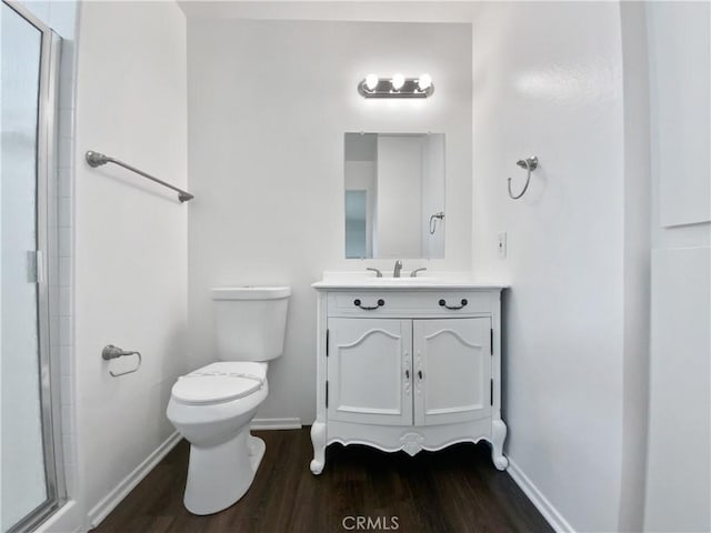 4739 Belmont Pl, Chino, CA 91710 - bathroom featuring baseboards, wood finished floors, toilet, a shower with shower door, and vanity