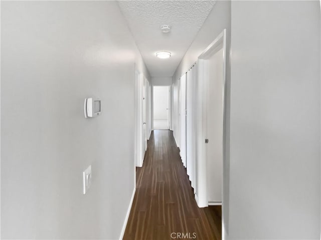 4739 Belmont Pl, Chino, CA 91710 - hallway featuring baseboards, dark wood finished floors, and a textured ceiling