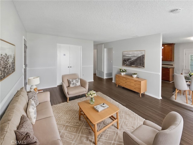 4739 Belmont Pl, Chino, CA 91710 - living room with dark wood-style floors, a textured ceiling, and baseboards