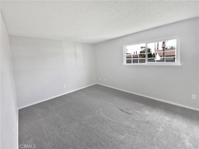 4739 Belmont Pl, Chino, CA 91710 - empty room with a textured ceiling, dark colored carpet, and baseboards