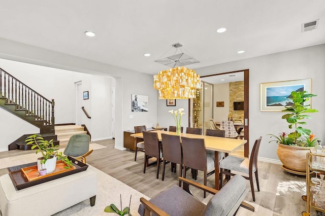 6497 Wayfinders Ct, Carlsbad, CA 92011 - dining room with stairs, light wood finished floors, recessed lighting, and a chandelier