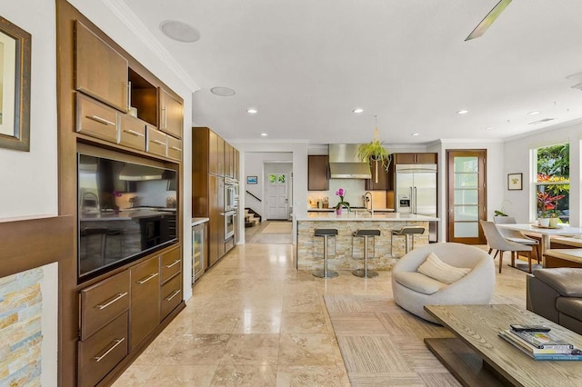 6497 Wayfinders Ct, Carlsbad, CA 92011 - living area with ornamental molding, recessed lighting, and wine cooler