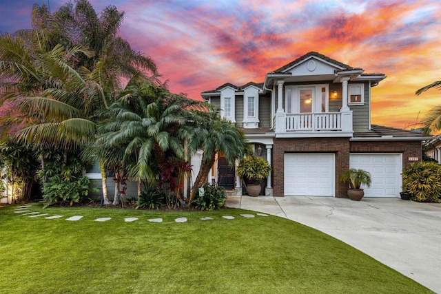 6497 Wayfinders Ct, Carlsbad, CA 92011 - view of front of house featuring an attached garage, concrete driveway, a yard, brick siding, and a balcony