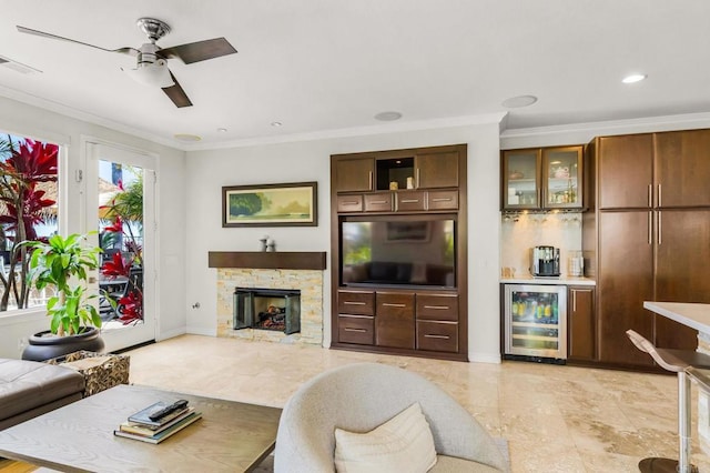 6497 Wayfinders Ct, Carlsbad, CA 92011 - living room featuring beverage cooler, crown molding, a ceiling fan, bar, and a stone fireplace