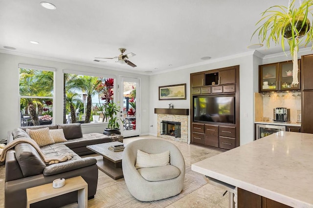 6497 Wayfinders Ct, Carlsbad, CA 92011 - living room featuring a stone fireplace, ceiling fan, ornamental molding, and recessed lighting