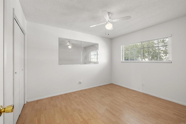 3168 Florine Dr, Lemon Grove, CA 91945 - unfurnished bedroom featuring light wood-style floors, a textured ceiling, a closet, baseboards, and a ceiling fan