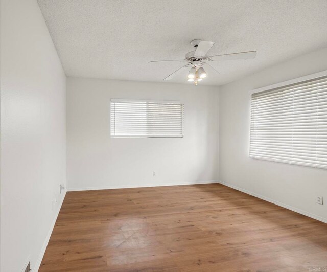 3168 Florine Dr, Lemon Grove, CA 91945 - unfurnished room with a textured ceiling, wood finished floors, ceiling fan, and baseboards
