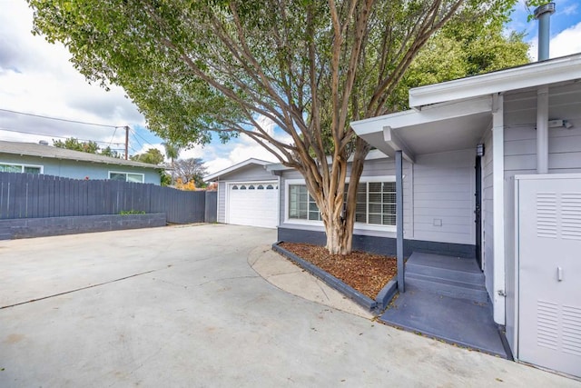3168 Florine Dr, Lemon Grove, CA 91945 - view of side of home featuring an attached garage, fence, and concrete driveway